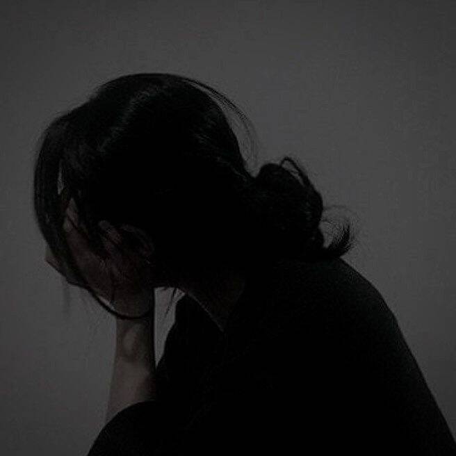 Foto de perfil triste de mujer con la mano en la cara